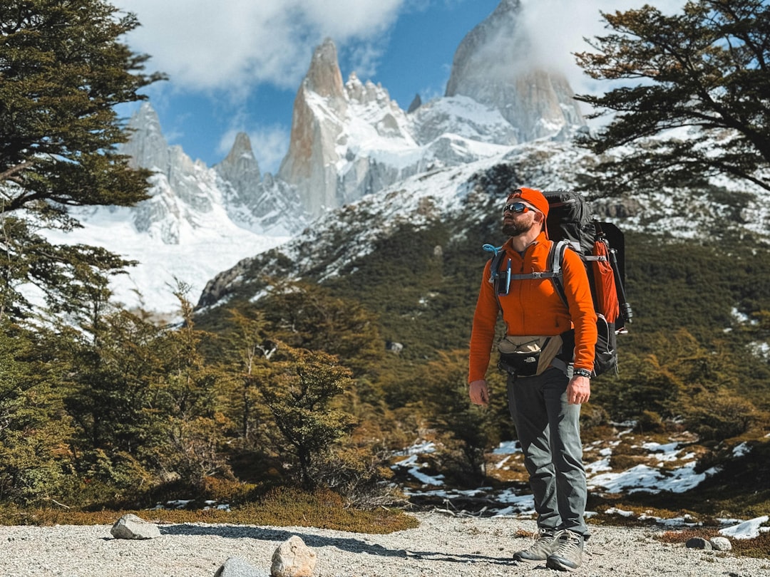 A man with a backpack is hiking in the mountains