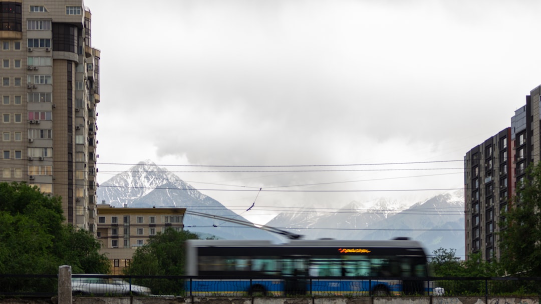 a train traveling through a city next to tall buildings