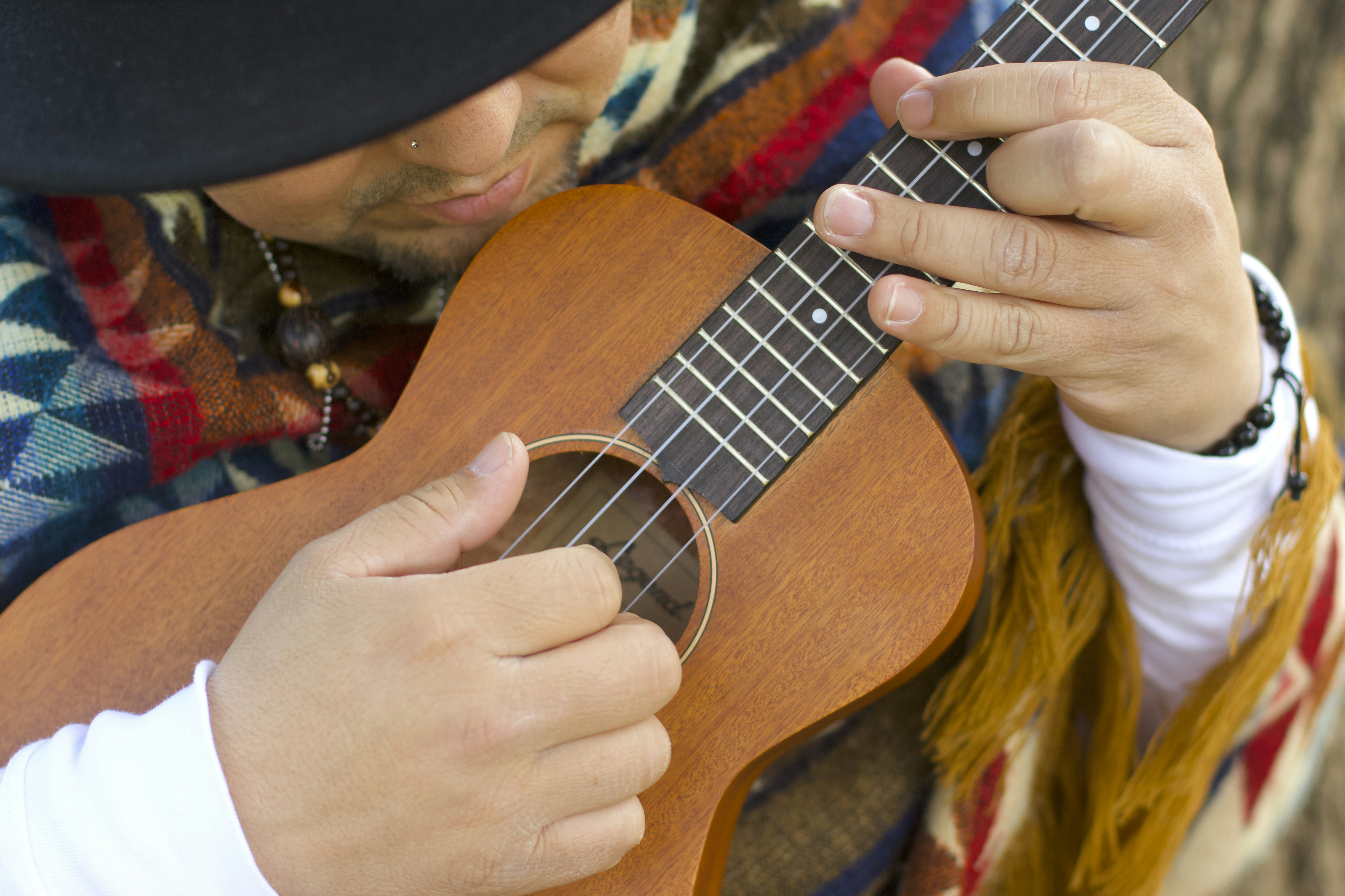 Ukulele Melbourne by Chile Vacay person playing brown ukulele