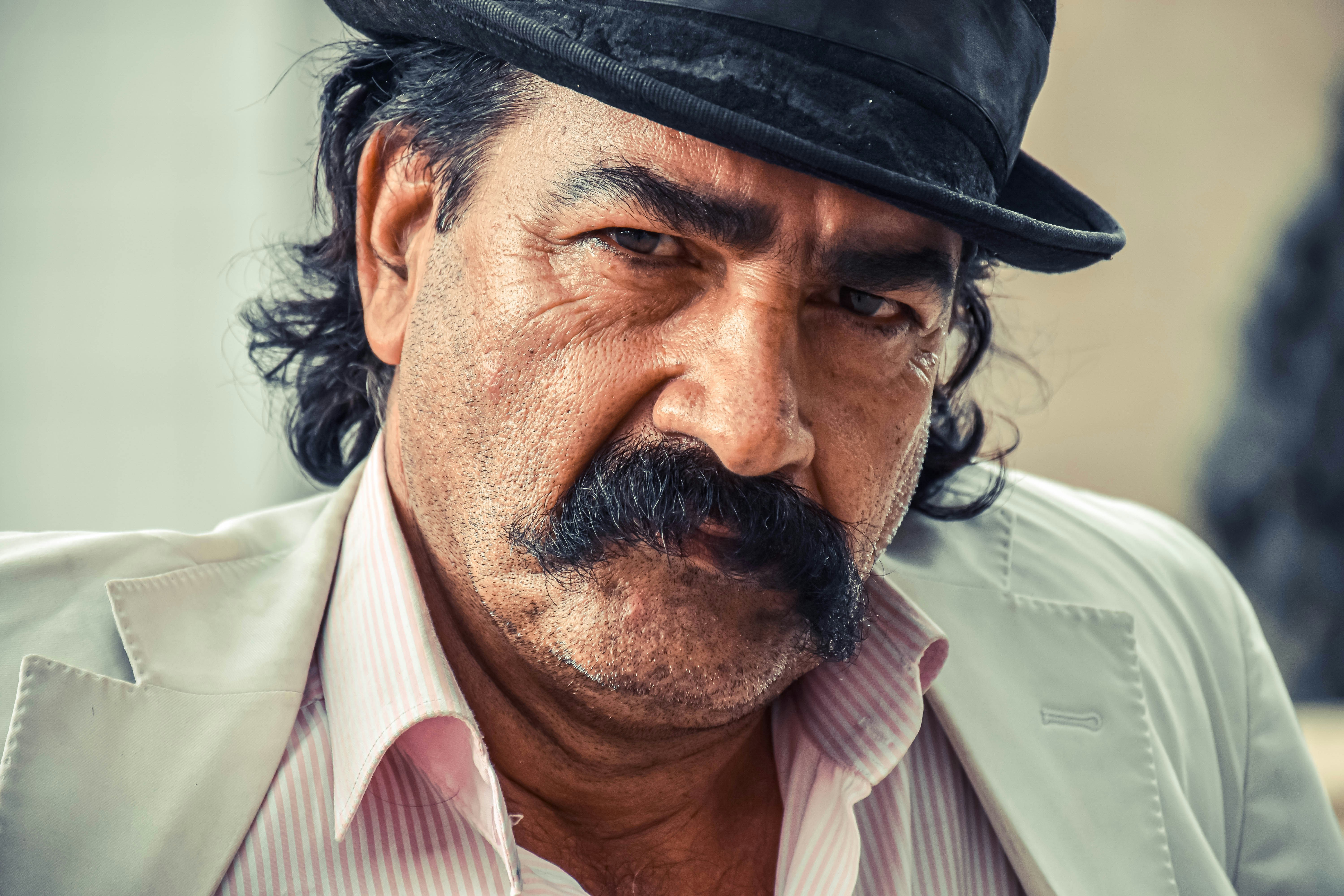 FAQ: Your Burning Questions Answered 🔥 by Chile Vacay man in white dress shirt wearing black fedora hat