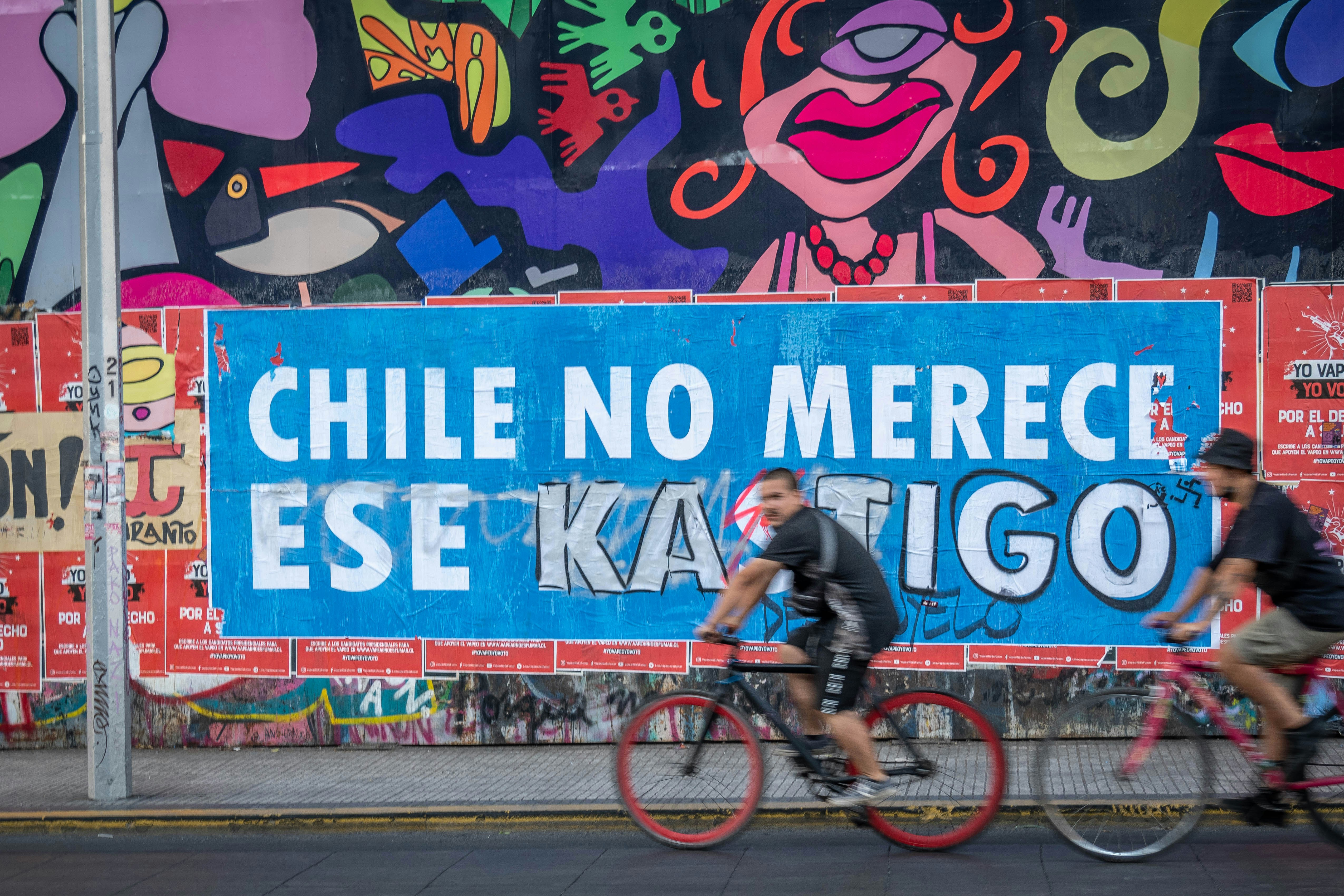 a couple of people riding bikes down a street