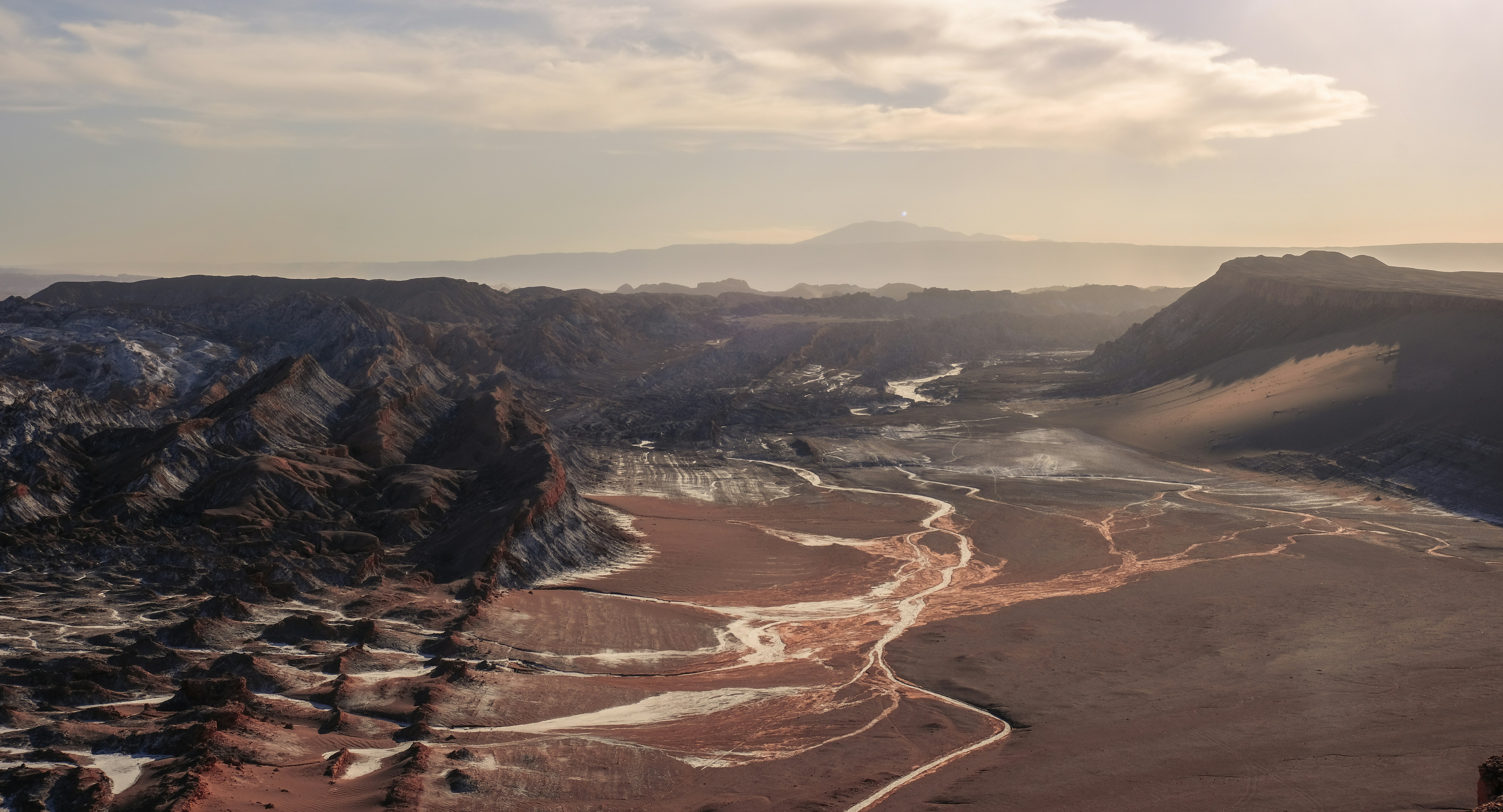 Valle de la Luna, Chile by Chile Vacay a view of a mountain range with a river running through it