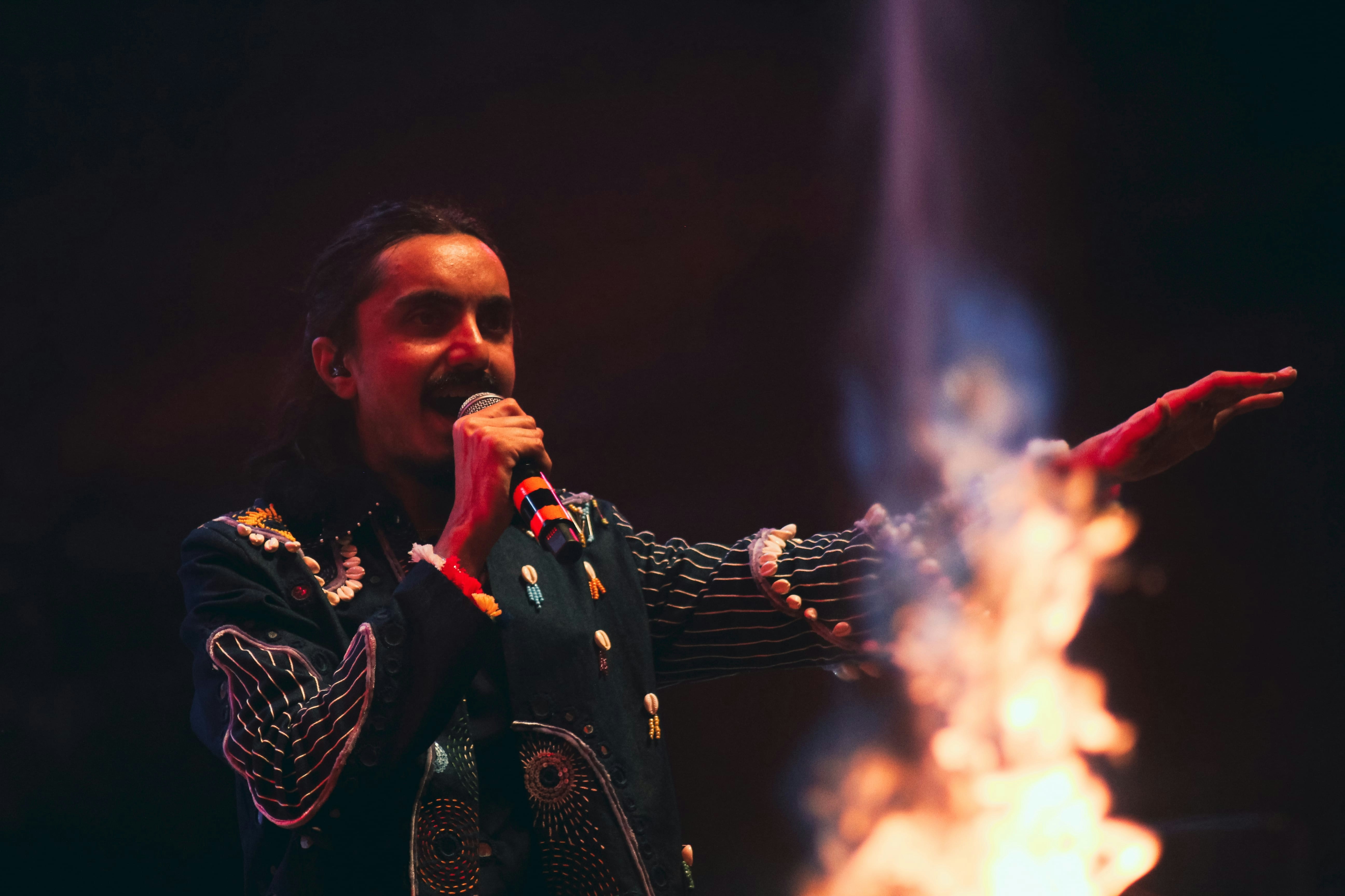 Conclusion: Why Chilean Musicians Are Here to Stay on the World Stage by Chile Vacay A man standing on a stage holding a microphone