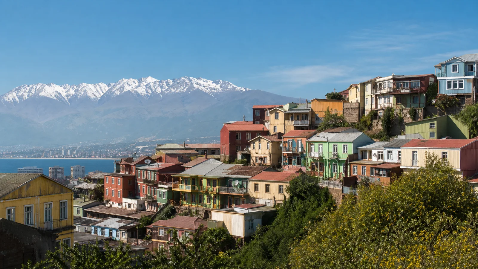 Editorial image of colorful Chilean hillside homes with an Andean backdrop for a culture, history, and adventure travel guide.